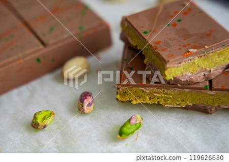 Trend Dubai chocolate with pistachio paste and kataifi dough. Confectionery handmade sweets at home in the kitchen.  119626680