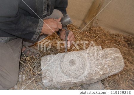 Hands of a master mason at a medieval festival in Portugal, working with stone using tools. Concept for reconstructing historical crafts 119159258