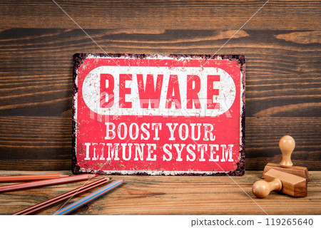 Boost your immune system. Beware sign with text on a wooden texture office table 119265640