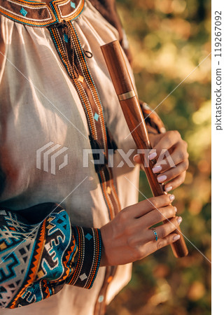 Hand Of Woman Playing On Woodwind Flute - Ukrainian Wooden Sopilka In Forest 119267092