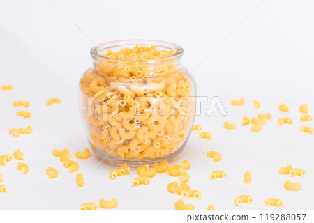 Uncooked Chifferi Rigati Pasta in Glass Jar on White Background 119288057