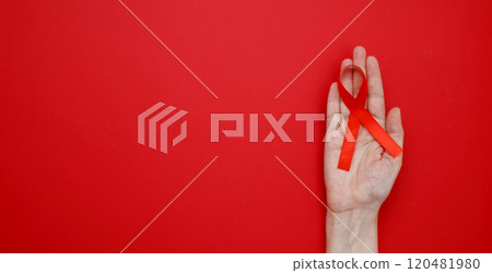 World AIDS Day. Woman holding red AIDS awareness ribbon 120481980