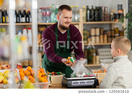 Seller weighs the candies 120561618