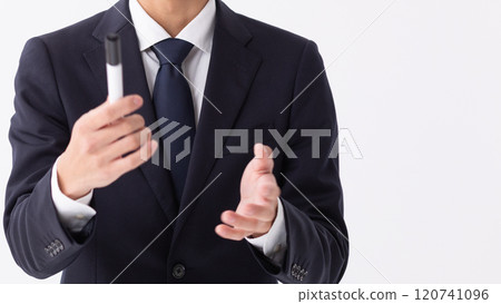 A person giving an explanation in front of a whiteboard (stock photo) 120741096