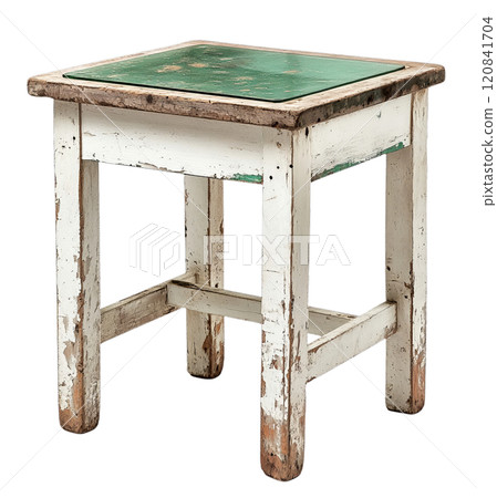 A small, white wooden table with a green top, featuring aged and cracked paint on its legs, is isolated on a transparent background. 120841704