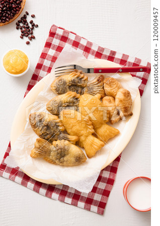 Red bean bungeoppang puff pastry and cream bungeoppang beautifully plated on a red checkered tablecloth 120009457