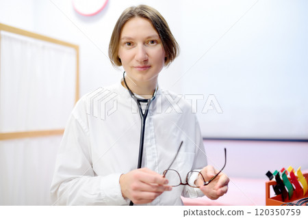 Portrait of female doctor cardiologist during appointment  120350759