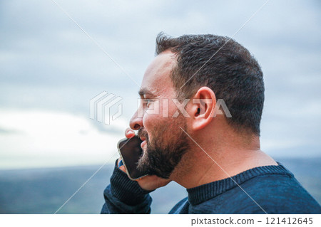 Man Nods Enthusiastically While On the Phone 121412645