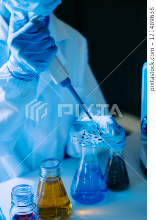 Female biotechnologist testing new chemical substances in a laboratory. 121489638