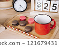 red mug with coffee and macaroons on a wooden tray on the background of an alarm clock and a calendar with the date December 25. Christmas coffee 121679431