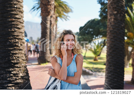 Beautiful tourist woman using smartphone on beachfront having phone call chatting on mobile phone enjoying summer vacation 121819027