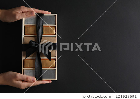 Chocolate bars in a gift box on a dark background 121923691