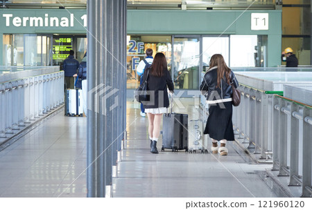 Tourists walking in the terminal corridor at Kansai Airport in winter 121960120