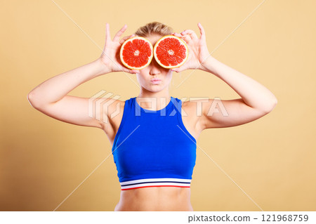 Woman holding grapefruit citrus fruit in hands 121968759