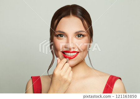 Young woman applying red lipstick. Make-up, beauty and fashion concept. 121163850