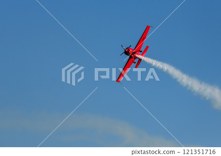 Stunt aerobatic plane performing stunts in air 121351716