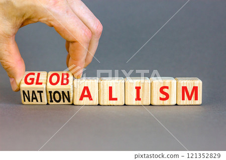 Globalism or nationalism symbol. Concept words Globalism or Nationalism on beautiful wooden blocks. Beautiful grey background. Businessman hand. Business globalism or nationalism concept. Copy space 121352829