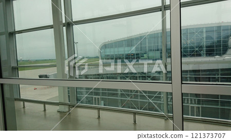 View through terminal windows onto airport architecture 121373707