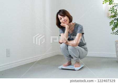 A woman disappointed on riding a scale 122407329