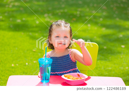 Toddler kid girl eating macaroni tomato pasta 122486189