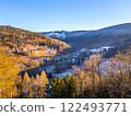 A picturesque railway stone bridge stands majestically in Novina, Krystofovo udoli, against the backdrop of Jested Mountain at winter sunset, illuminating the serene landscape with warm hues. 122493771