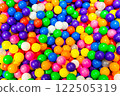 A cheerful ball pit filled with bright and colorful plastic balls. 122505319