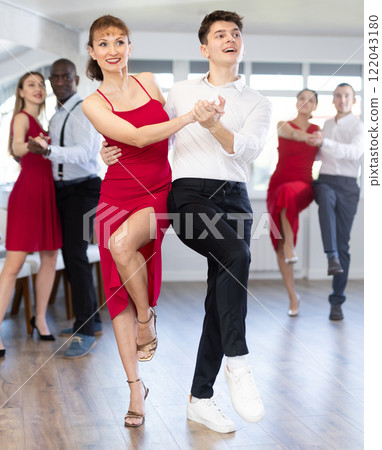 Young guy and adult woman dance twist 122043180