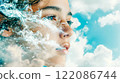 Face of beautiful young girl in water splashes against blue sky looking dreamily into a future. Wonderful child dreaming. Spellbound dreamy kid gaze. 122086744