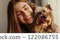 Beautiful girl hugs and cuddles beloved Yorkshire Terrier dog. Woman and doggy laugh together. Human-animal friendship. Happy together. Canine life. 122086755