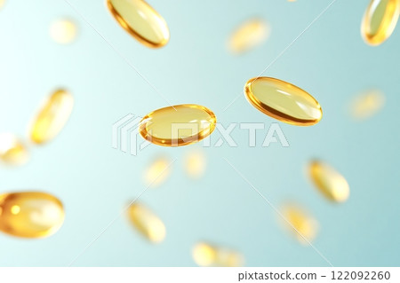 Fish oil capsules floating on a light blue background 122092260