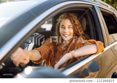 Stylish woman driving car. Traveler is the driver. Automobile travel. Sharing car. Lifestyle concept 122266823