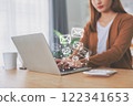 Woman using computer laptop and sending online message with email icon 122341653