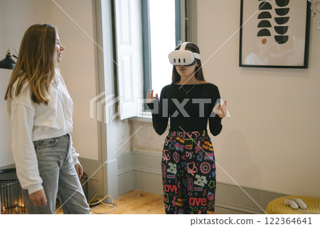 Two Girls Actively Engaging with Fascinating Virtual Reality Technology Experiences 122364641