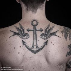 a man with an anchor tattoo on his back