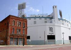 an old brick building next to a large white building