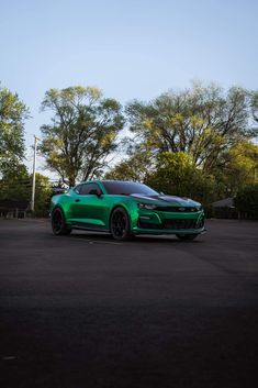 a green sports car parked in a parking lot