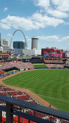 an empty baseball stadium with the st louis arch in the background