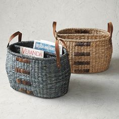 two wicker baskets with leather handles are shown side by side, one has a magazine in it and the other is empty