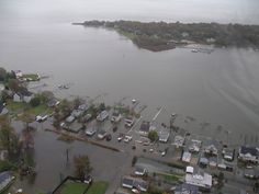 an aerial view of a flooded area with houses and boats in the water, as seen from above