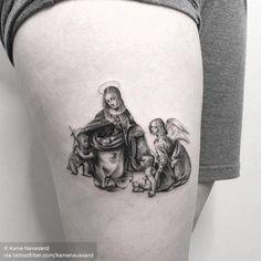 a woman's thigh with an image of the virgin mary and baby jesus on it