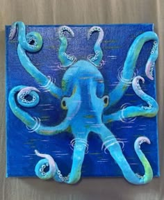 an octopus is painted on a piece of wood