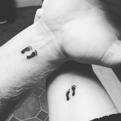 two people with matching tattoos on their arms