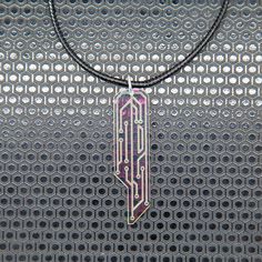 For the discerning Corpo, this iridescent piece is an elegant non-UV reactive rendition of our classic Data Chip Necklace. They are laser cut and engraved on a mesmerizing iridescent acrylic. This acrylic radiates a captivating array of colors--pink, yellow, purple, green, and sometimes blue--creating a dynamic visual display that evolves with the changing light. Key Features: Exclusive custom design Laser cut and engraved Shifting colors in natural light Specifications: Material: Special clear iridescent cast acrylic Length: 2 1/4 inches Necklace: 17-19 inch adjustable cotton cord & ball chain necklace Combine this necklace with a matching set of Data Chip Earrings at a discounted price. Futuristic Jewelry Necklaces, Cyberpunk Necklace, Tech Necklace, Futuristic Necklace, Cyberpunk Jewelry, Cyberpunk Accessories, Futuristic Jewelry, Iridescent Acrylic, Chip Necklace