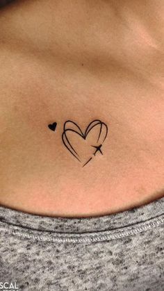 a woman's stomach with a heart tattoo on it