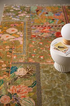 a rug with a lamp on top of it next to a book and magazine holder