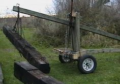 an old wooden cart sitting on top of a lush green field