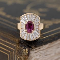 The best pop of color on the finger with this ruby ballerina ring. The ruby is a beautiful, rich deep reddish pink, and contrasts so beautifully against the white diamonds. And speaking of which, the long and narrow tapered baguettes are the most dramatic we have seen in sometime - the perfect back drop for this gorgeous ruby. 18kt yellow gold, size 5.5 & fully resizable.Ruby is estimated to be VS1 type II clarity.Diamonds are estimated to be G/H colors & VVS/VS1 clarities.Please see qua Modern Mens Rings, Ballerina Ring, Art Jewelry Earrings, Baguette Diamond Rings, Bespoke Rings, Solitaire Setting, Back Drop, Antique Engagement, Antique Engagement Rings