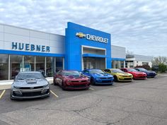 several cars parked in front of a chevrolet dealership with the words, hubner