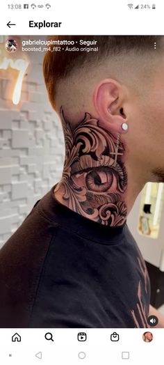 a man with a tattoo on his neck and behind the ear is looking at something