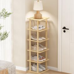 a wooden shoe rack with four pairs of shoes on it in front of a door